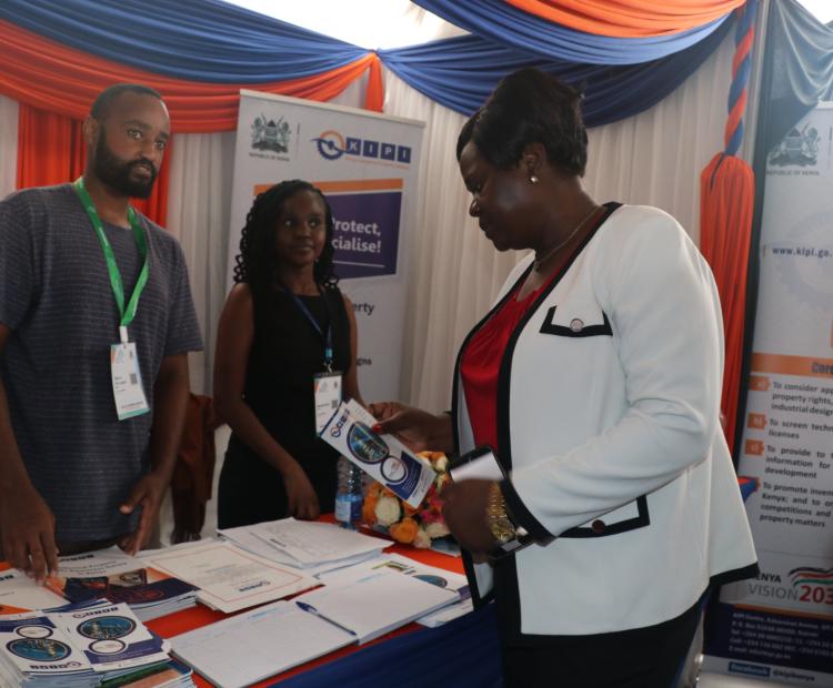 3.	Hon. Gladys Wanga, Governor Homa Bay County, engages Benson Baituru (Left) and Brenda Haro when she toured of the Institute’s Stand during the 2nd Homa Bay International Investment Conference 2024 held at the Tom Mboya University, Homa Bay, from 27th February to 29th February 2024
