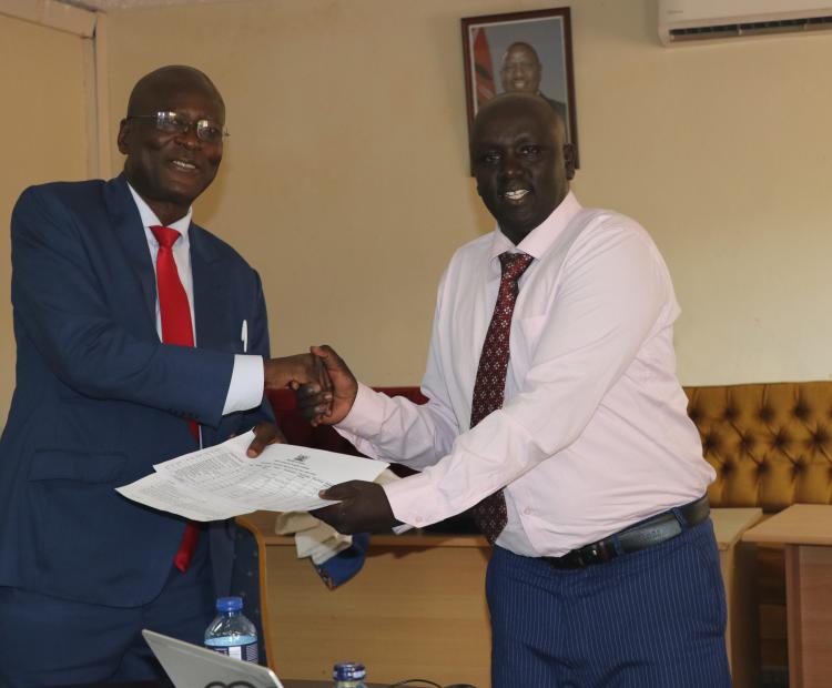 Vincent Sutei (Right), Team Leader of the Evaluators, presents to the Managing Director, John Onyango, a report of their evaluation of the Institute’s performance for the Financial Year 2023-2024